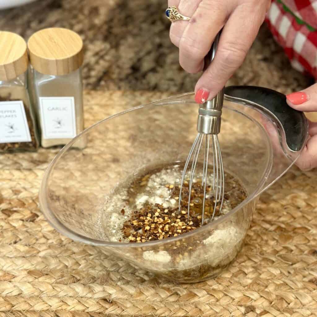 Mixing together oil ingredients for spicy fire crackers.