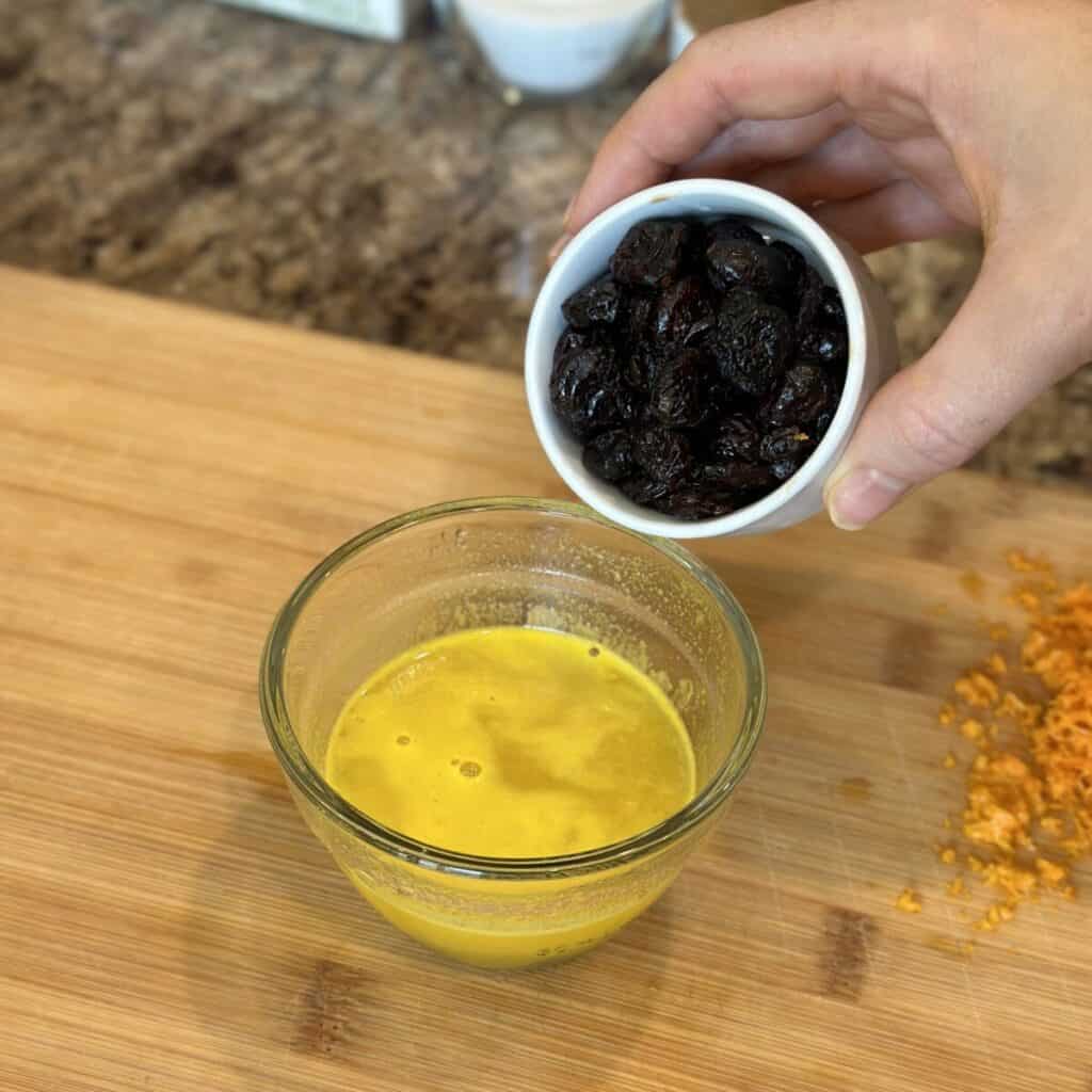 Mixing cranberries with orange juice.