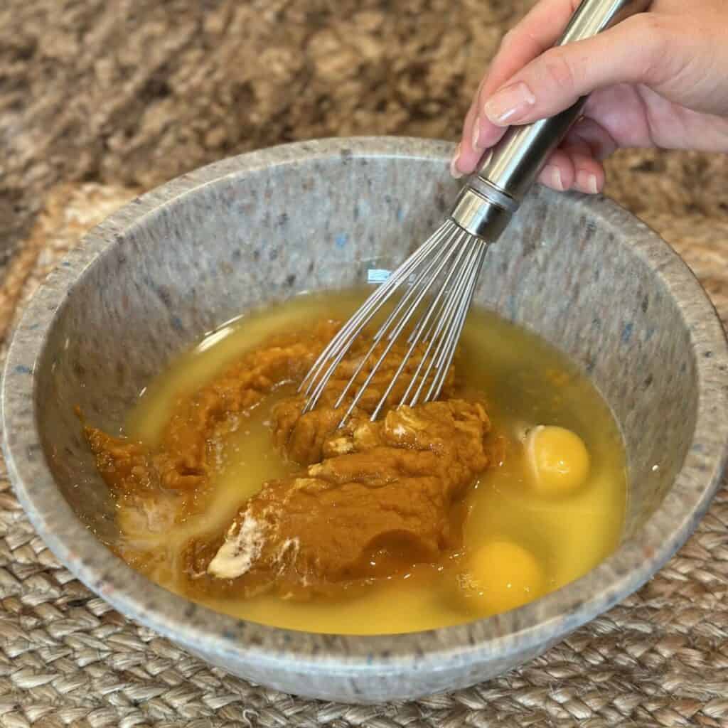 Mixing the wet ingredients for pumpkin coffee cake.