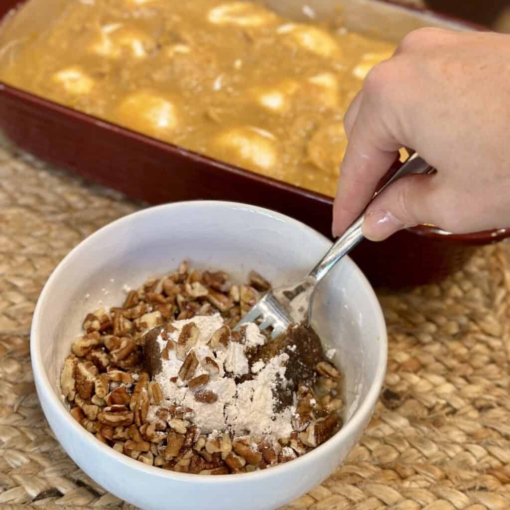 Making the streusel topping for sweet potatoes in a small bowl.