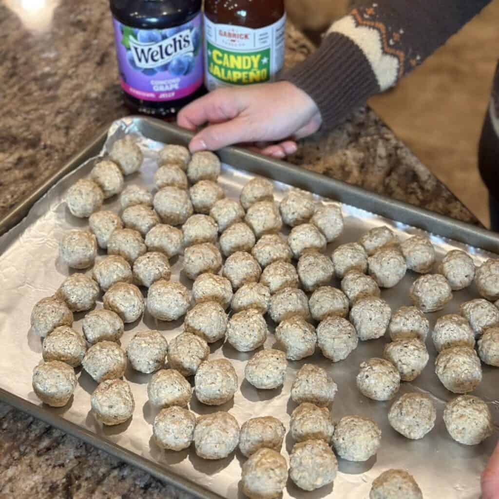 A tray of meatballs ready to be baked.