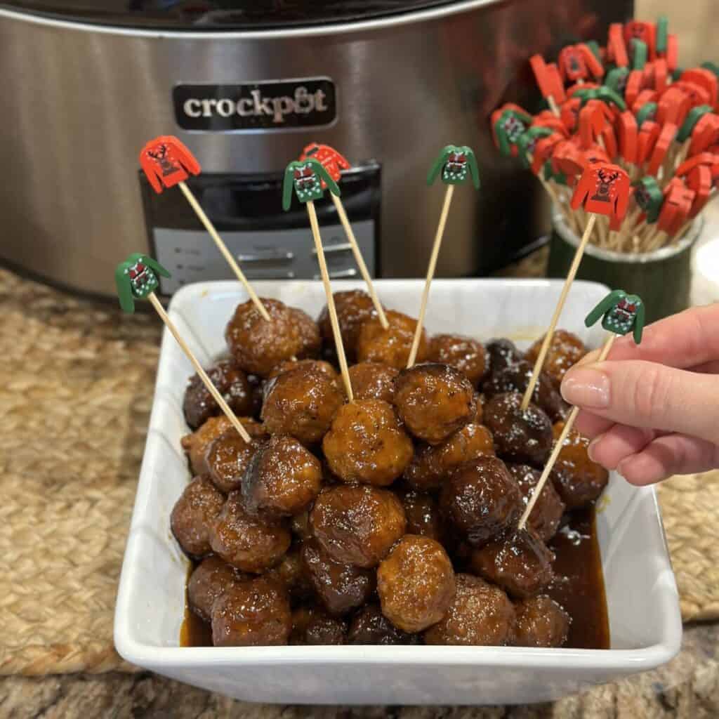 A bowl of grape jelly and barbecue sauce meatballs. 