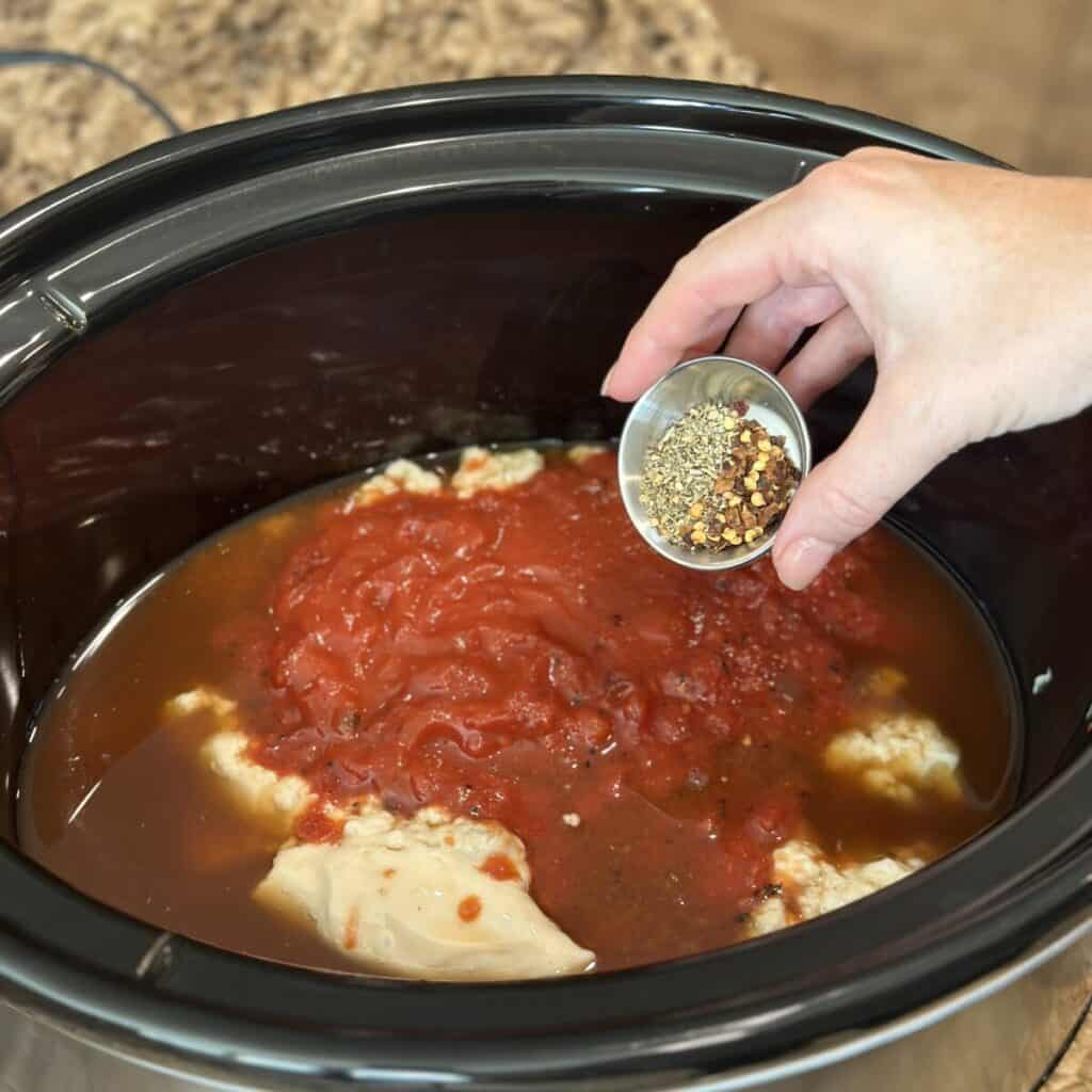 Combining ingredients in a skillet for slow cooker hamburger helper.