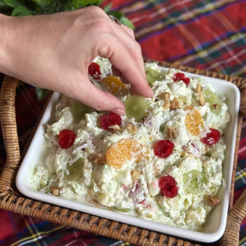 Garnishing a bowl of pistachio ambrosia salad.