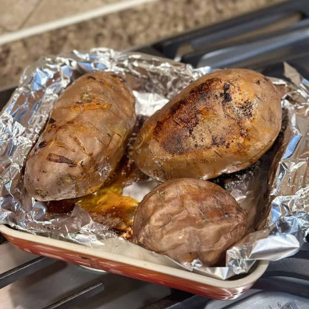 Baked sweet potatoes on a pan.