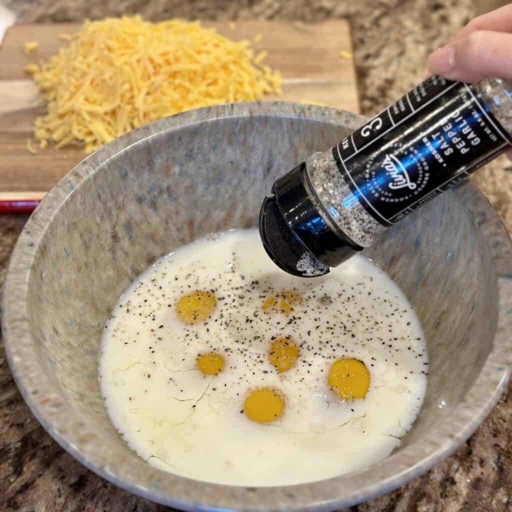 Making the egg mixture for biscuits and gravy casserole.