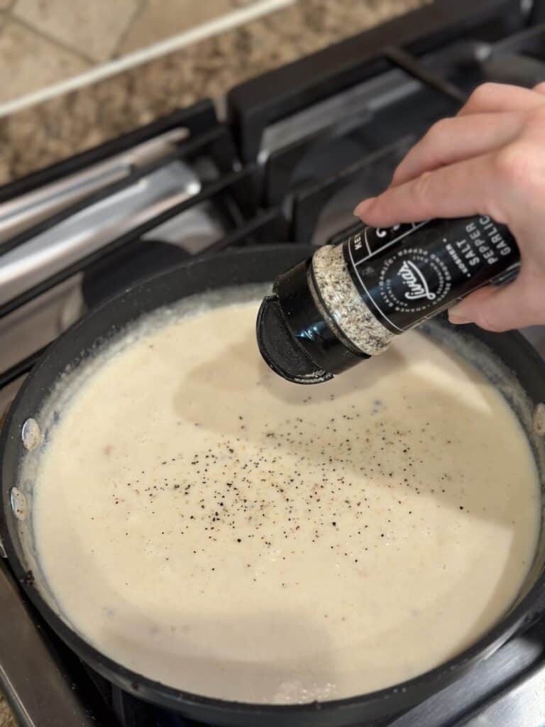 Seasoning gravy in a pan.