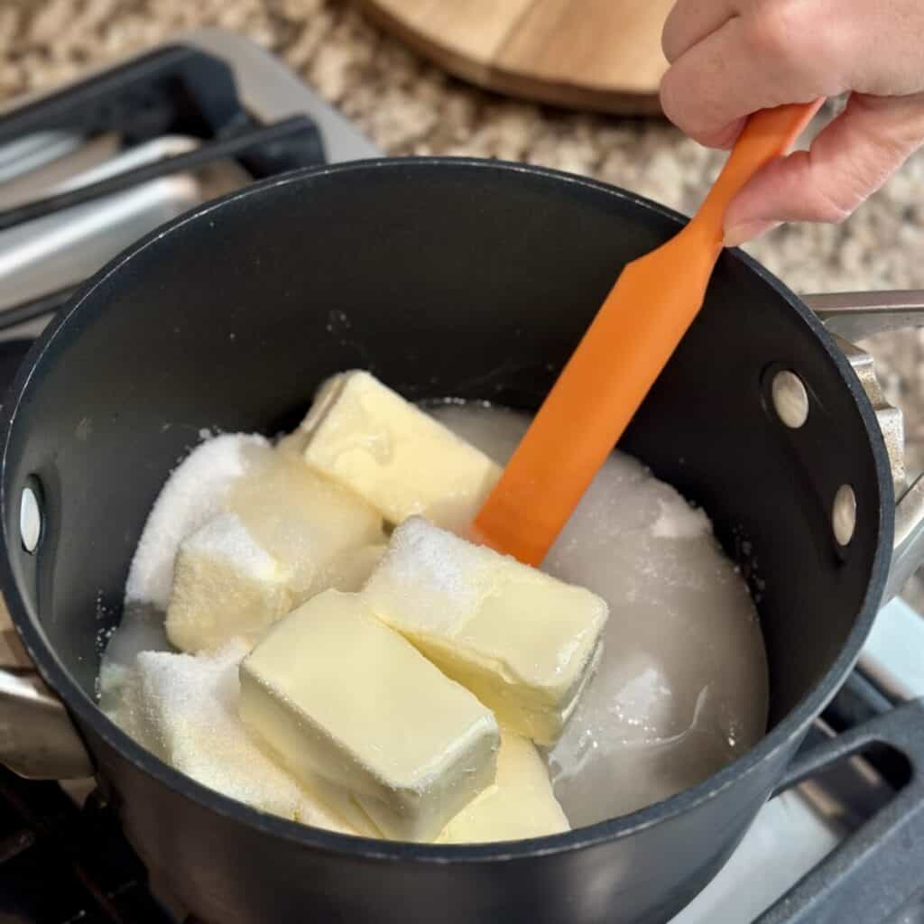 Melting butter and sugar in a pan.