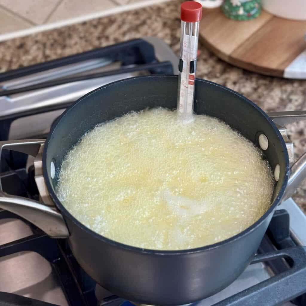 Boiling butter and sugar in a pan.