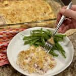 A plate of chicken cordon bleu casserole and green beans.