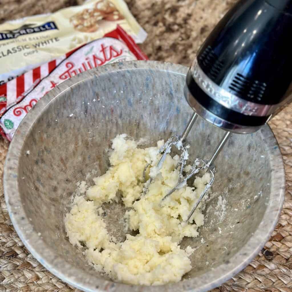 Whipping sugar and butter in a bowl.