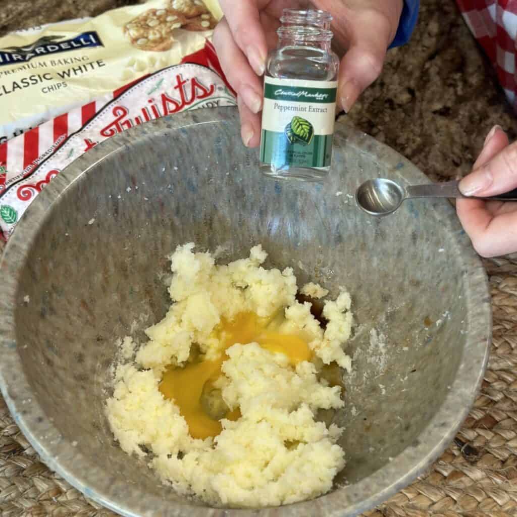 Adding extract to cookie dough.