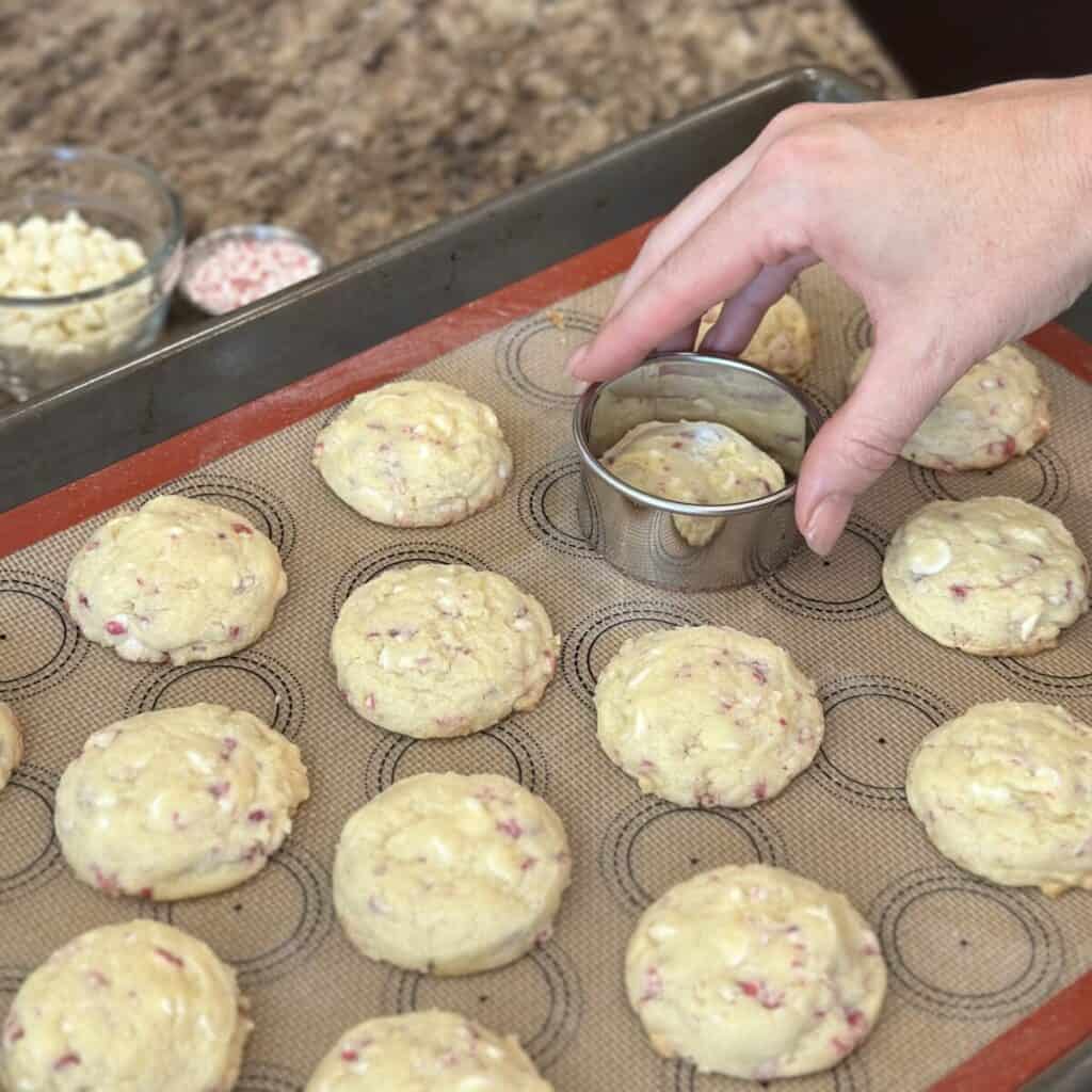 Using a cookie cutter to round off the edges of cookies.