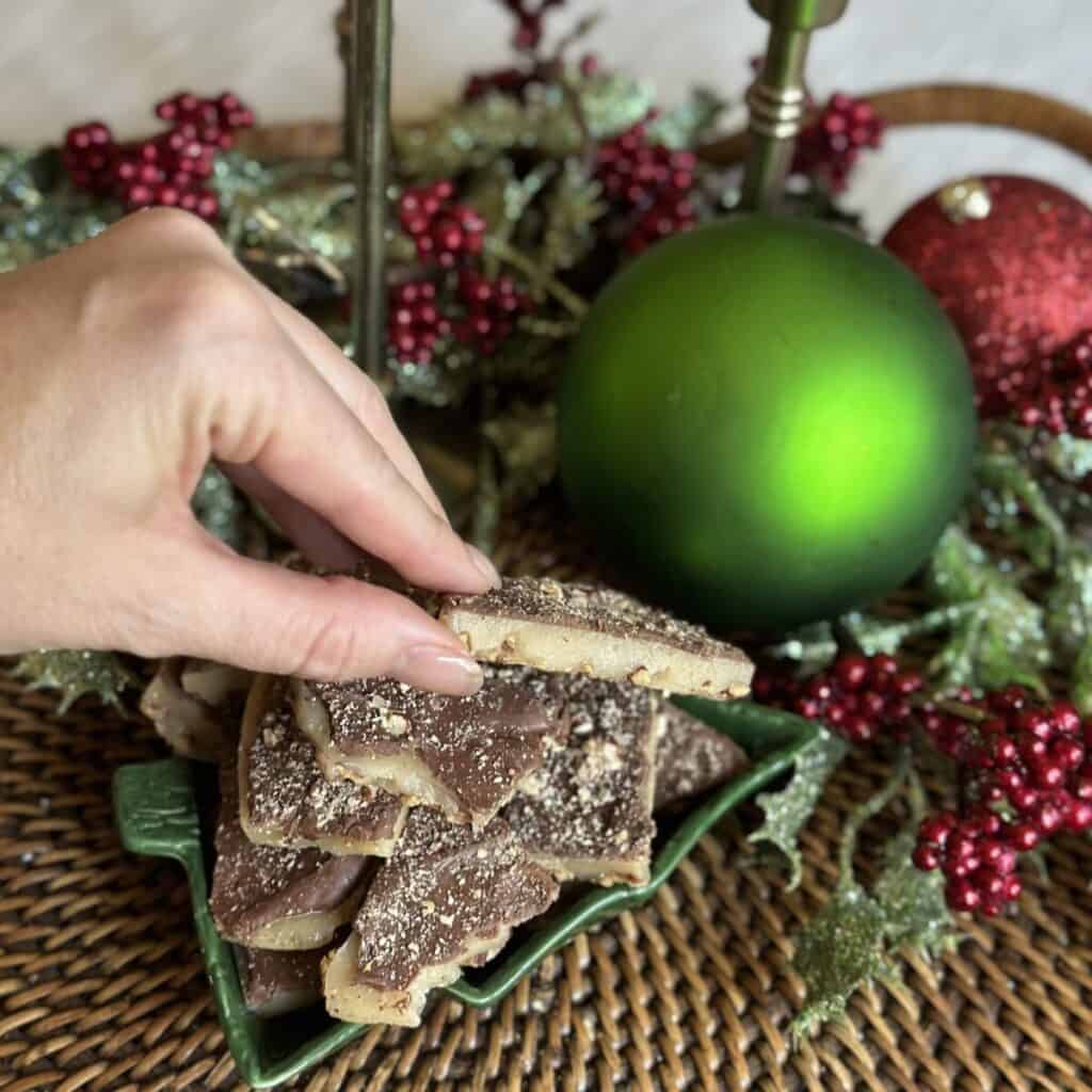 Holding a piece of butter toffee.