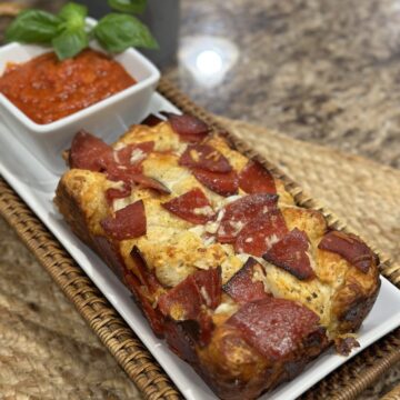 A pizza monkey bread on a plate.