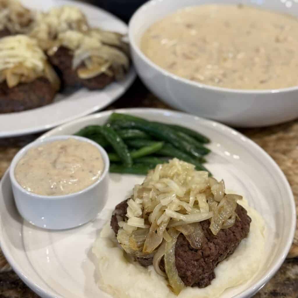 Hamburger steak with onion gravy on a plate.