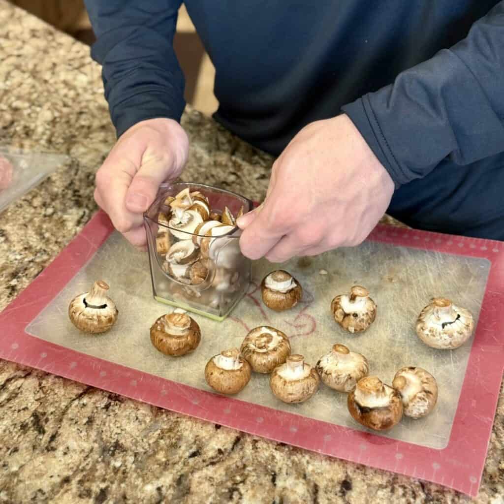 Slicing mushrooms on a cutting board.