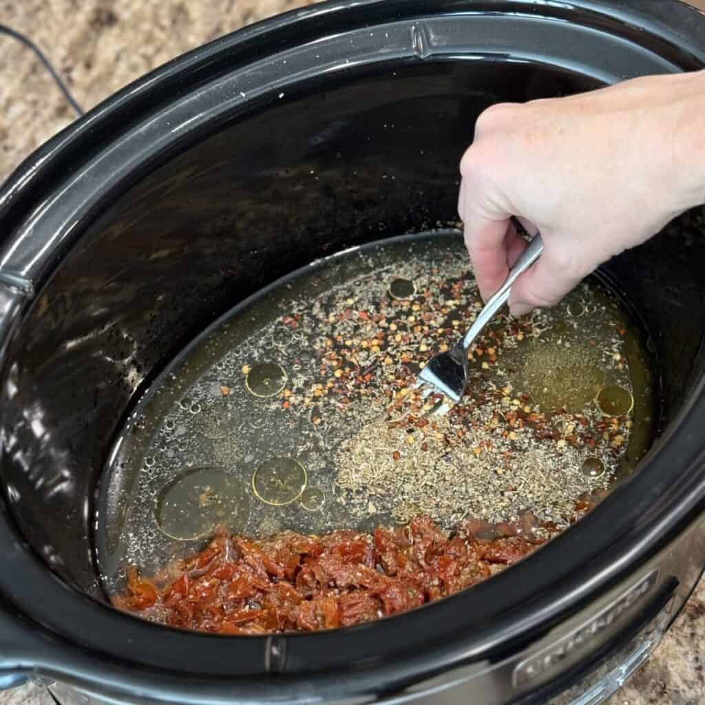 Whisking together the broth base for crock pot marry me chicken.