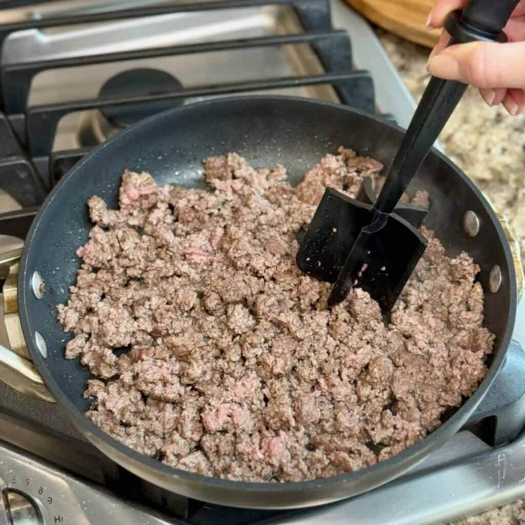 Browning ground beef in a pan.