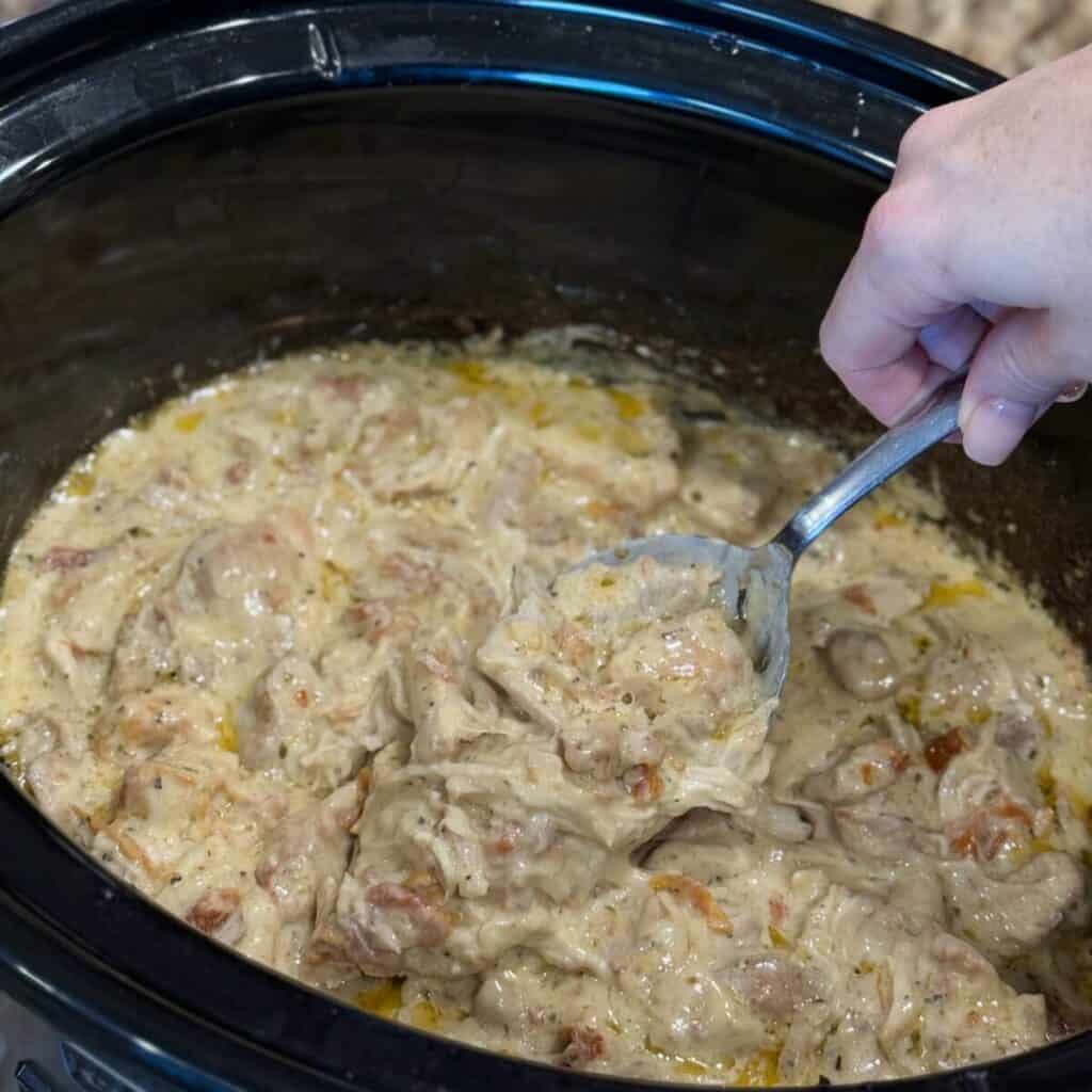 Scooping up a serving of crock pot marry me chicken.