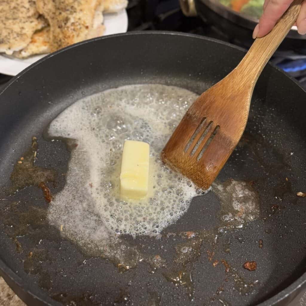 Melting butter in a skillet.