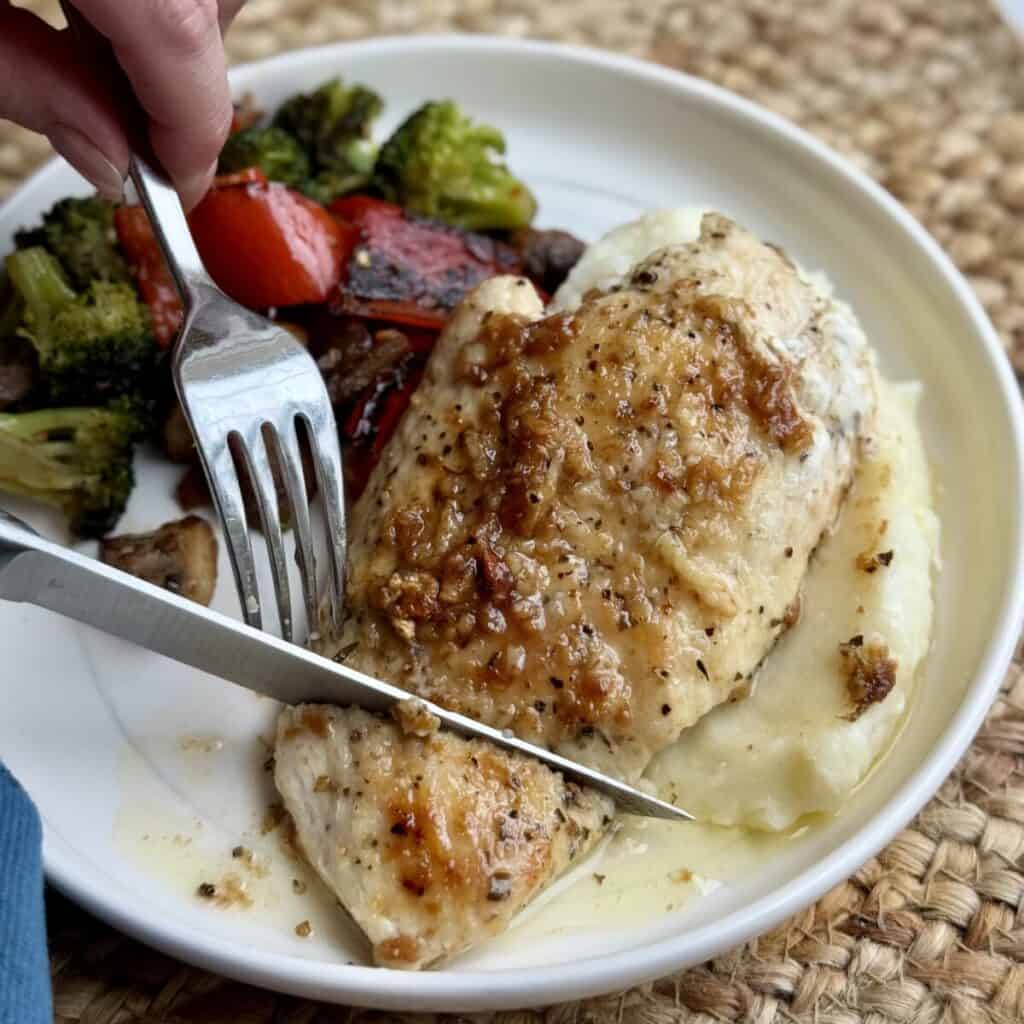 Garlic butter chicken on a plate and vegetables.