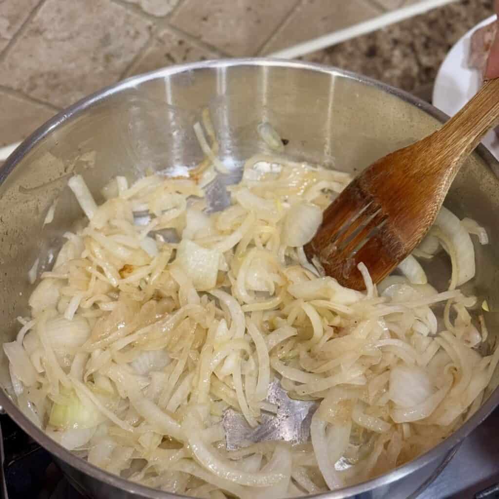 Sautéing onions in a pan.