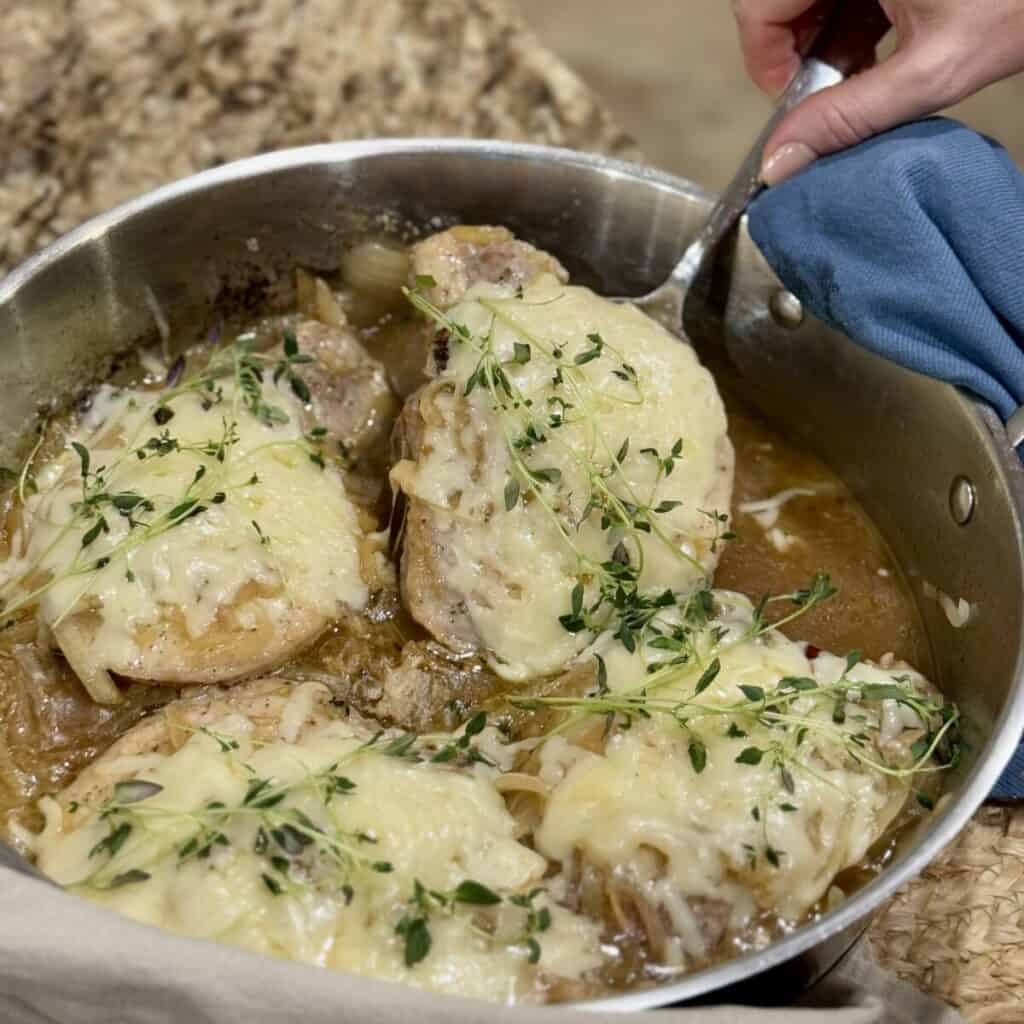 French onion pork chops in a pan. 