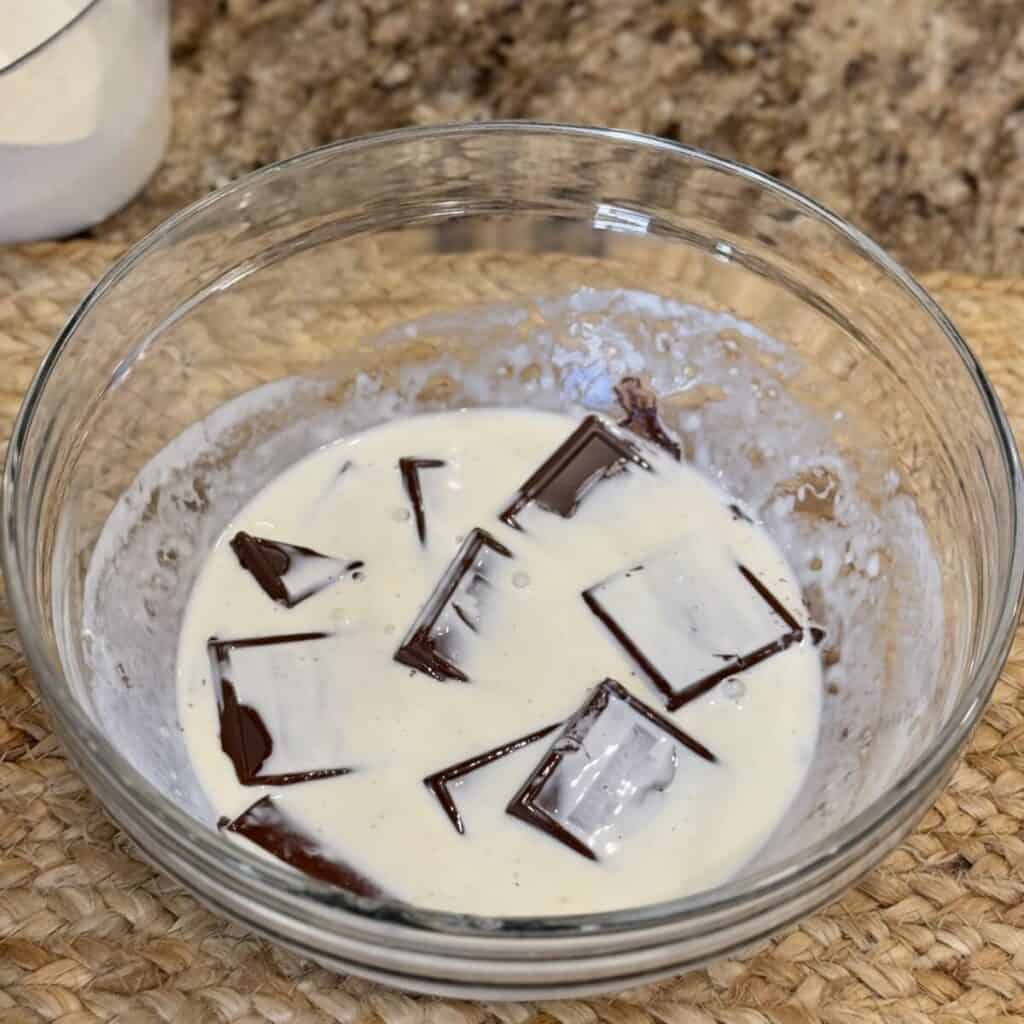 Whipping cream on chocolate in a bowl.