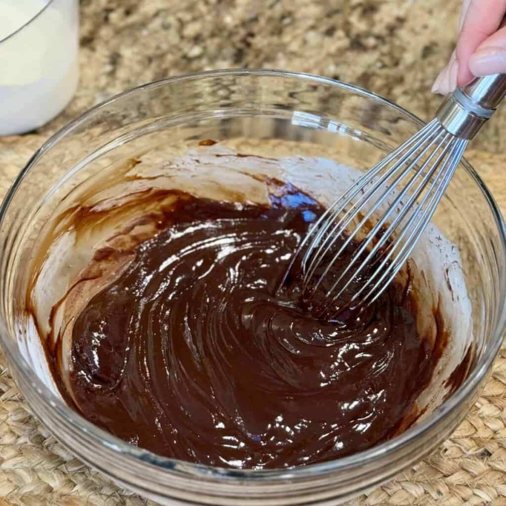 Whisking ganache in a bowl.