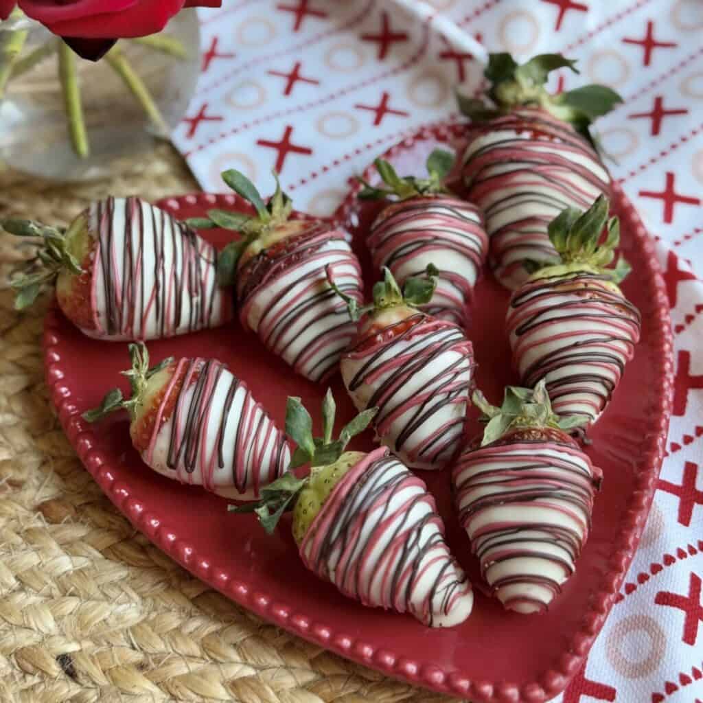 A plate of white chocolate covered strawberries.