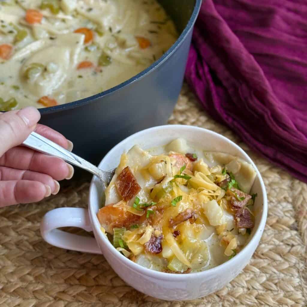 A pan and bowl of pierogi soup.