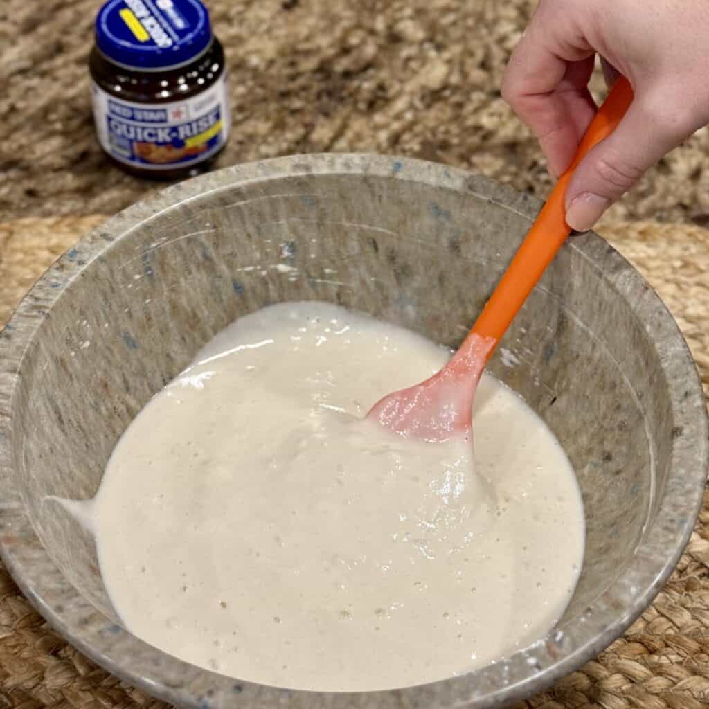 Blending the ingredients in a bowl for quick yeast rolls.