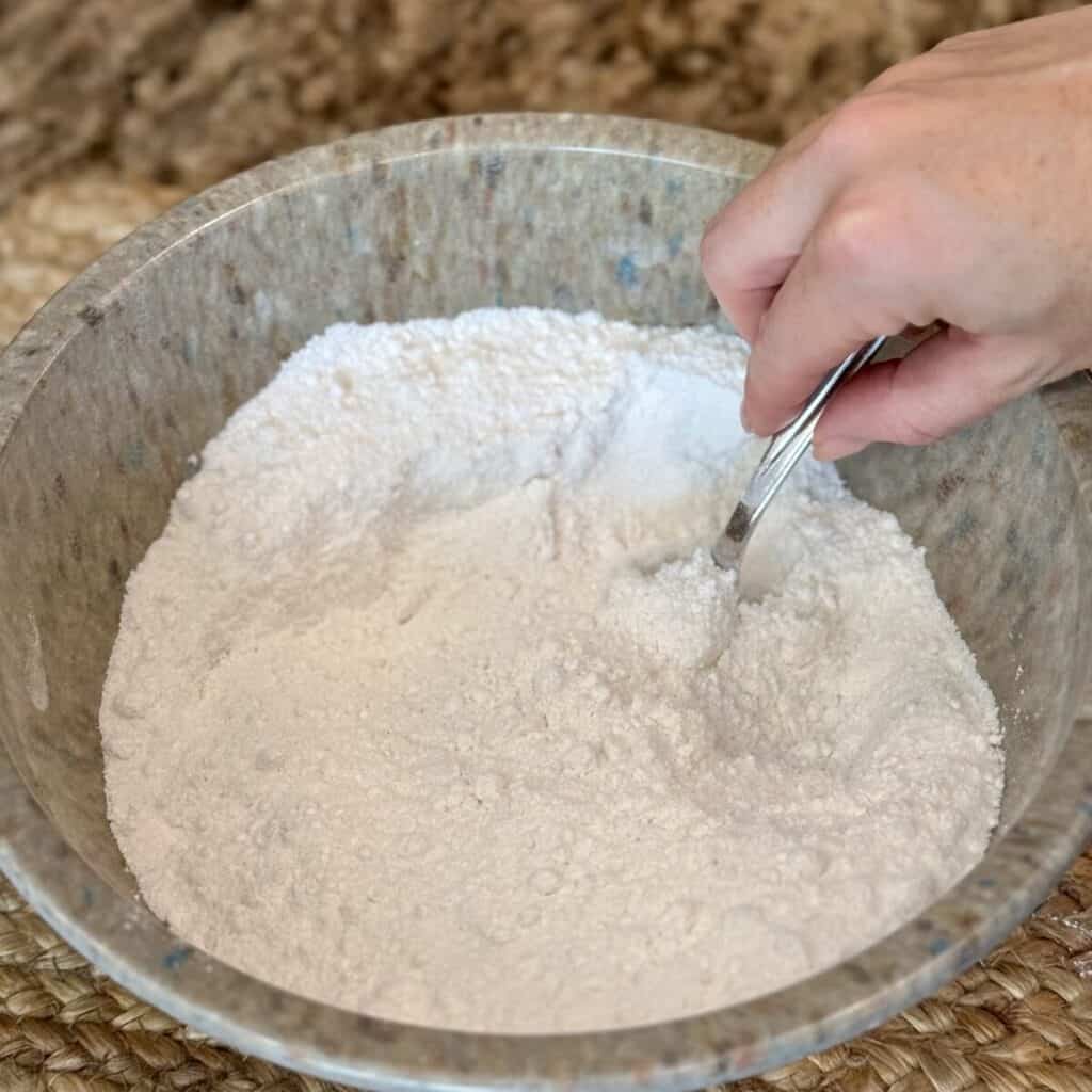 Whisking flour in a bowl.