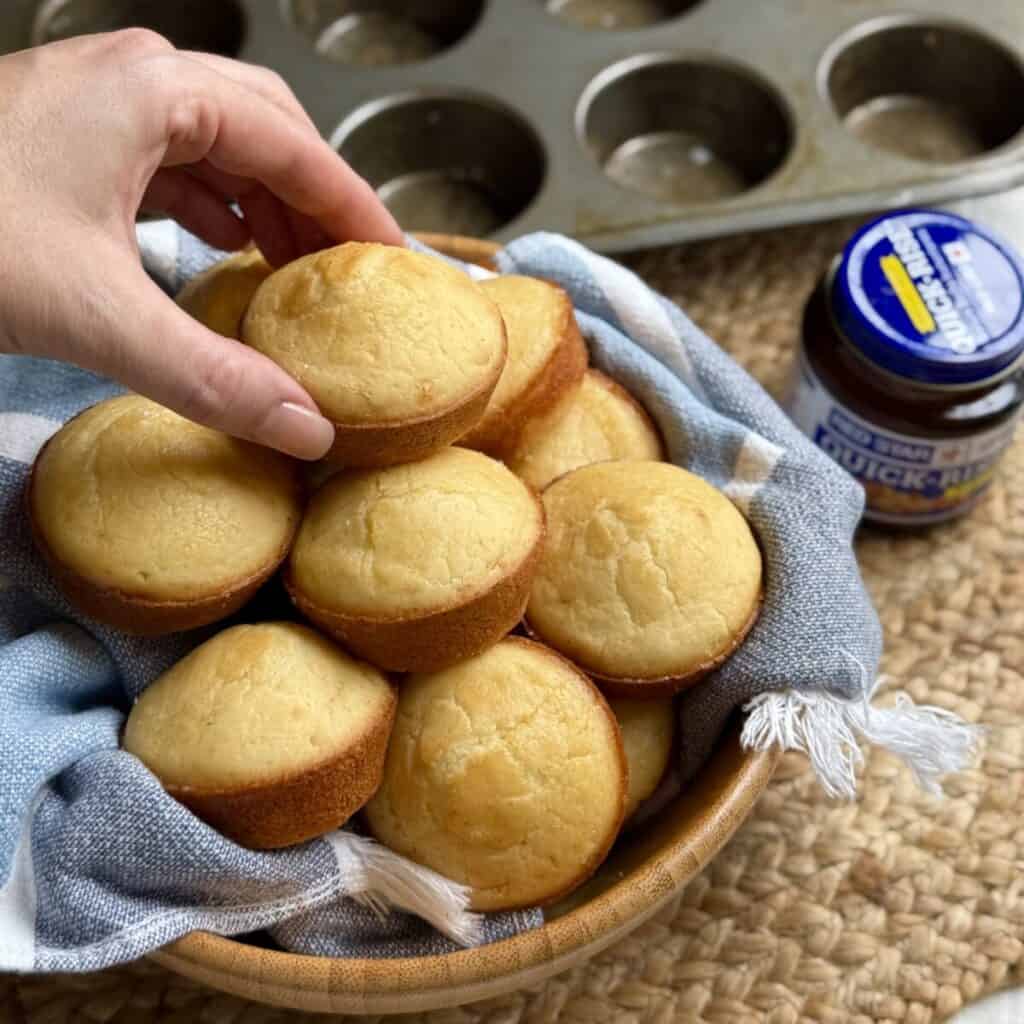 Grabbing a quick yeast roll from a bowl.